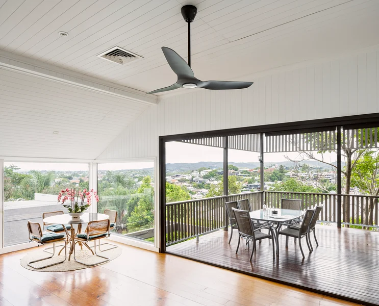 Dining room with ceiling fan and city view