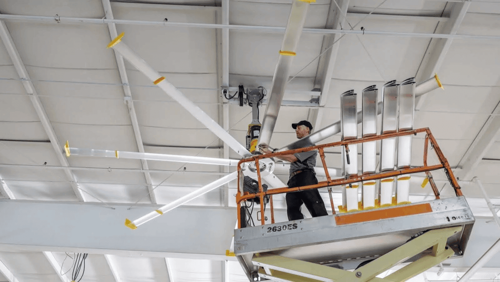 Employee installing a Big Ass Fan for a High-Ceiling Building
