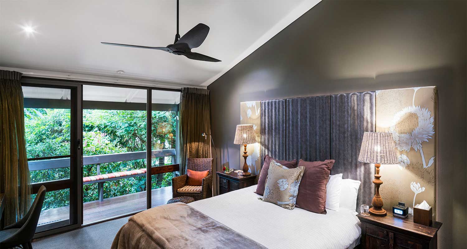 small black ceiling fan in a modern bedroom with a sloped ceiling