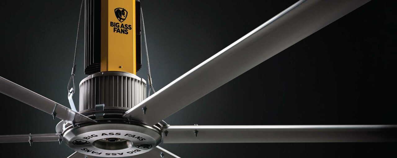 A close up view of an HVLS industrial ceiling fan by Big Ass Fans, featuring a sleek design and heavy-duty materials.