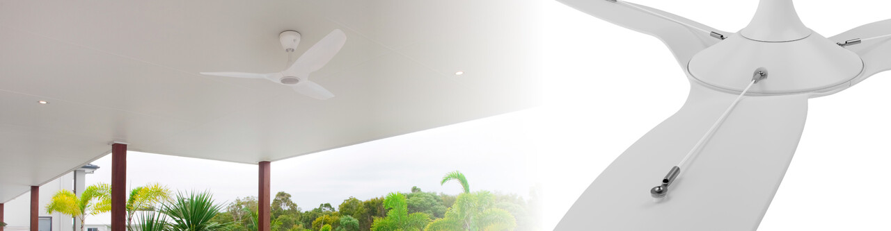 The view of an outdoor covered patio with a white Haiku outdoor ceiling fan.